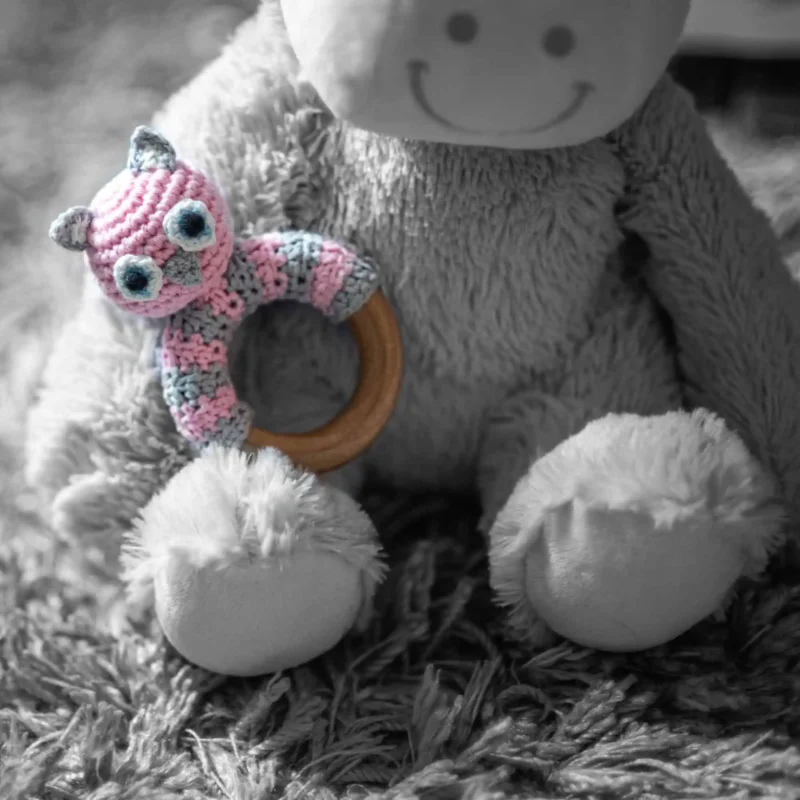 Rattle Ring Owl LUNA – Attached to Plush Toy Owl LUNA rattle ring attached to a gray plush toy against a gray plush background