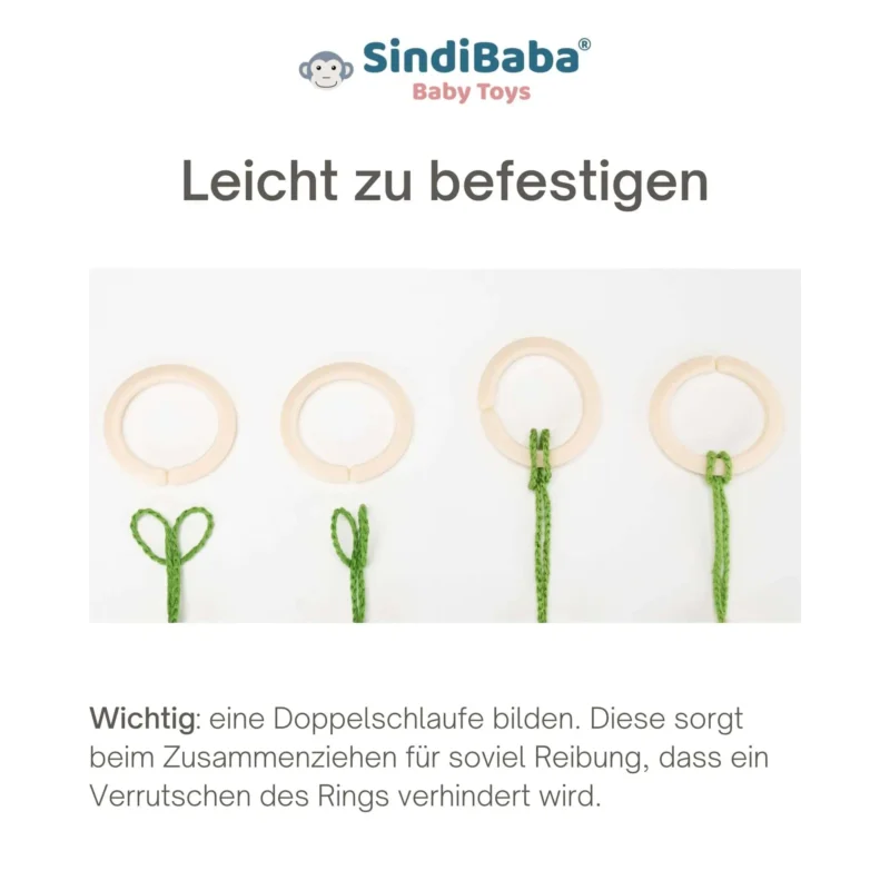 Anleitung – Schlaufe zum Ring Schlaufe der Kinderwagenkette wird in einen hellbeigen Befestigungsring eingefädelt.