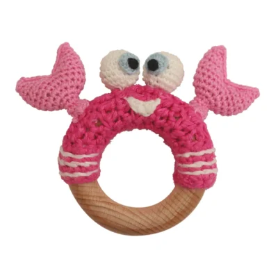 Crab PINCER rattle ring with crocheted yarn surface and untreated beechwood ring, front view isolated