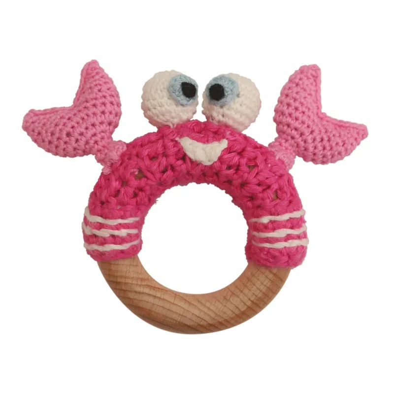 Crab PINCER rattle ring with crocheted yarn surface and untreated beechwood ring, front view isolated