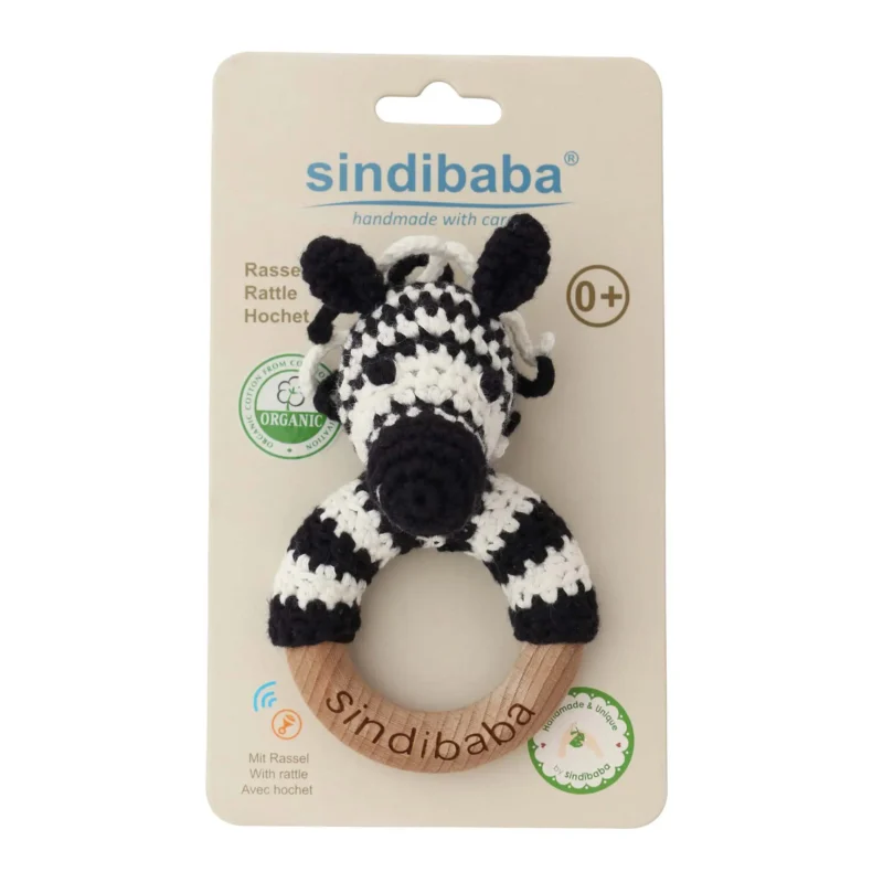 Rattle Ring Zebra STRIPEY – Packaging Front Zebra STRIPEY rattle ring with crocheted yarn surface in transparent packaging, front view for retail display