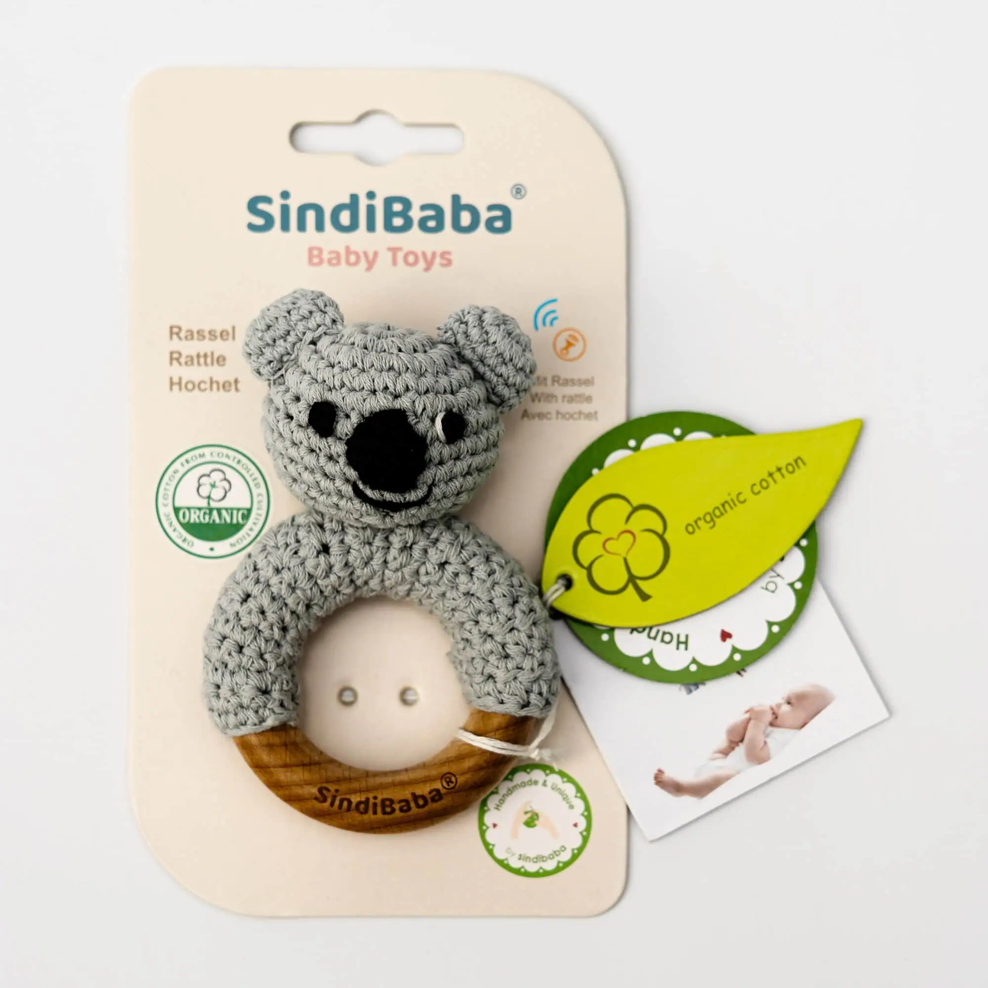 Koala ring rattle fixed to the cardboard backing, front view in retail condition