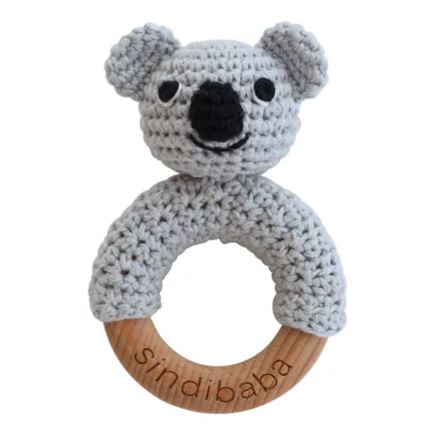 Koala ring rattle with crocheted yarn surface and untreated beechwood ring, front view isolated