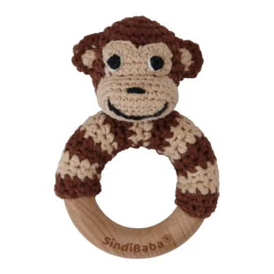 Monkey ring rattle with crocheted yarn surface and untreated beechwood ring, front view isolated