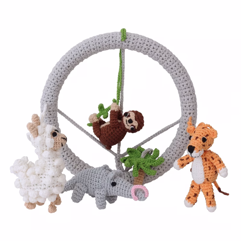 12549-baby-mobile-south-america-lifestyle-animals Creative isolated scene showing the vertical, light grey crocheted ring of the SOUTH AMERICA mobile with crocheted jungle animals arranged in front